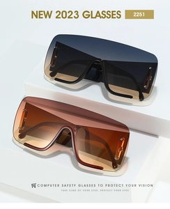 Detail view of oversized gradient lens sunglasses with side metal ornaments and PC frame