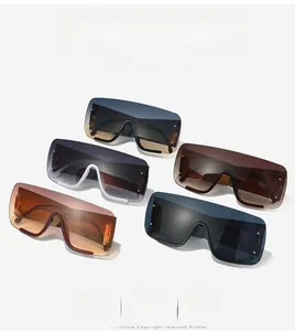 Five pairs of oversized shield sunglasses in assorted colors on a neutral background