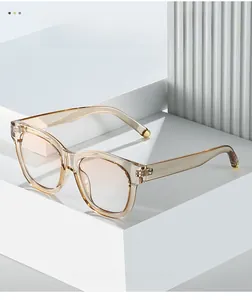 Detailed close-up of transparent tea oval sunglasses with premium metal hinge accents