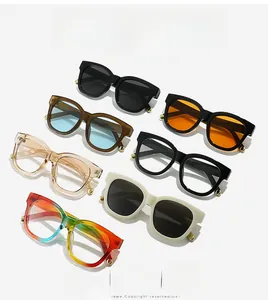 Detail view of oval sunglasses featuring gold rivet accents and premium frame textures