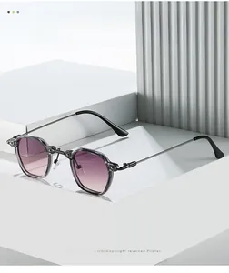 Detail of retro punk sunglasses featuring purple gradient lenses and thin black metal temples