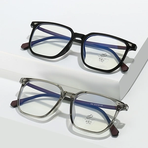 Square blue light blocking glasses in black and translucent grey on geometric stands