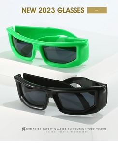 Close-up of futuristic sports sunglasses in green and black on minimalist white display