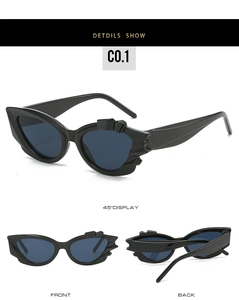 Three-view display of black cat eye sunglasses with geometric jagged edge frames
