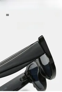Detailed macro view of black glossy cat-eye sunglasses hinge and sleek frame texture