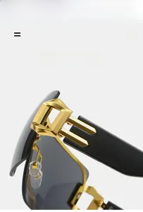 Detail view of premium black sunglasses showing gold hinges and flexible material