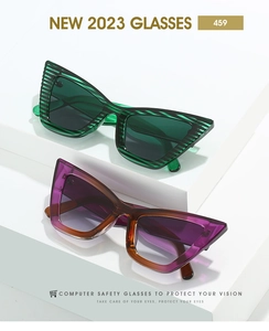 Detail of green and purple cat eye frames on geometric minimalist display