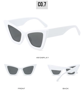 Detail view of white cat-eye sunglasses with thick temples and dark grey lenses