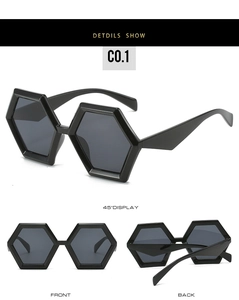 Detail view of black hexagonal sunglasses with dark grey lenses and geometric frames