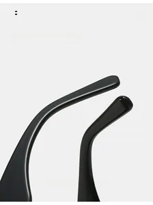 Close-up of sleek black curved temples on premium cat-eye sunglasses with high gloss finish