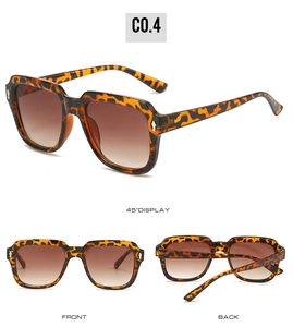 Detail view of square leopard print sunglasses with brown gradient lenses and metal arrows