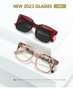 Close-up of square glasses frames with metal rivets on minimalist display steps