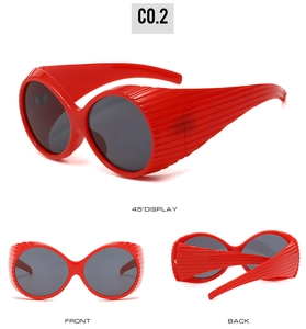 Three-angle views of retro red oval sunglasses with wide frames and striped side details
