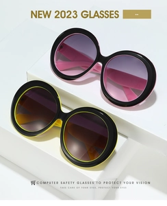 Detail of oversized round sunglasses with two-tone frames and gradient lenses