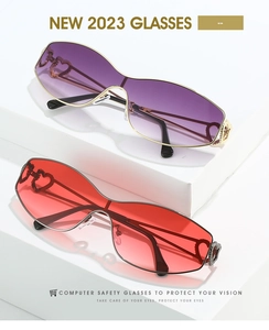 Detail view of heart-shaped sunglasses featuring purple and red gradient lenses on white blocks