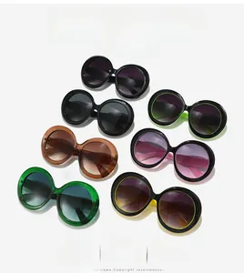 Flat lay of oversized round sunglasses in multiple colors including tortoiseshell and green