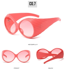 Three-way view of coral pink oversized oval sunglasses with unique 3D pleated texture frames