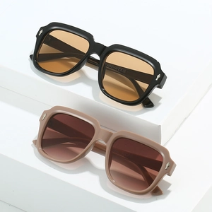 Modern square sunglasses in black and beige pink colors on a white minimalist platform