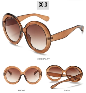 Three perspectives of amber oversized round sunglasses with brown gradient lenses