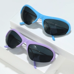 Futuristic cat-eye sports sunglasses with blue and purple frames in a minimalist setting