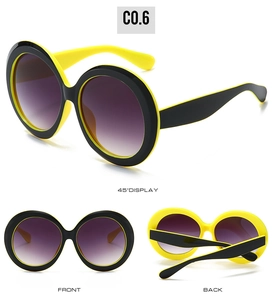 Detail of round oversized sunglasses with yellow-black frame and purple gradient lenses
