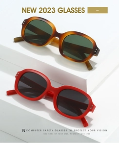 Detail view of vintage square sunglasses with stylish metal rivets on a white stand