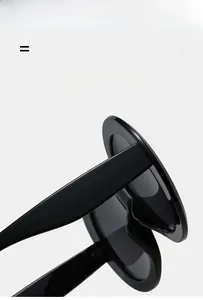 Detail showing the ultra-light and super elastic black wide temple on oversized round sunglasses