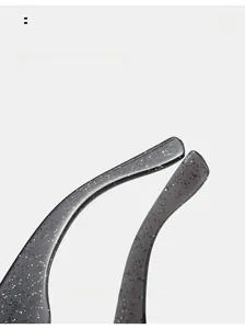 Detail view of curved mirror legs with silver glitter in translucent gray frame