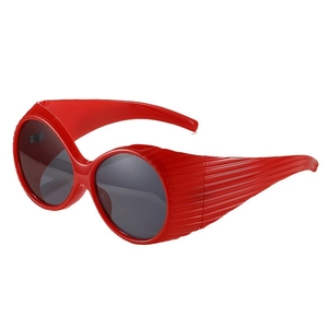 Retro oval oversized sunglasses with bright red frames and textured striped temples