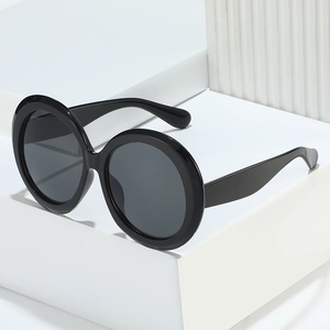 Fashion oversized round sunglasses with black frames and dark lenses for women