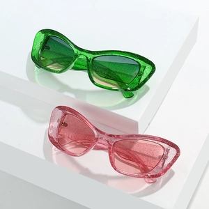 Oversized cat-eye glitter sunglasses in green and pink with sparkling sequin frames