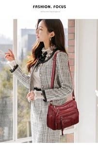 Detail showing burgundy multi-pocket shoulder bag with woven texture on a model