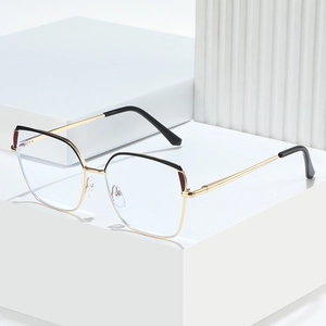 Women's cat-eye geometric metal glasses frame in black and gold on a white pedestal