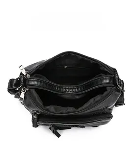 Top view of black multi-compartment crossbody bag showing organized storage space