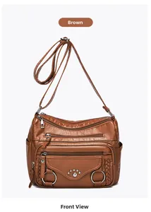 Front view of yellow faux leather multi-pocket crossbody bag with vintage rivet details