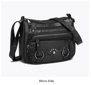 Side view of black PU leather crossbody bag with multiple zippers and cat paw studs