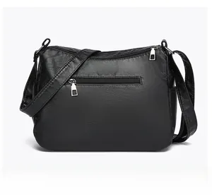 Rear view of black pebbled leather crossbody bag with zipper pocket and side pockets