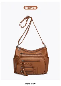 Detail view of multi-pocket tan faux leather shoulder bag with woven textures