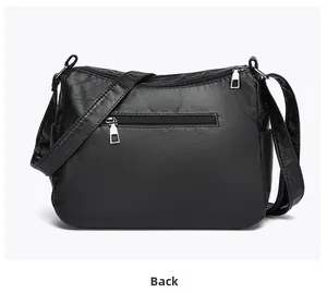 Detailed back view of black multi-zipper shoulder bag with soft pebbled leather texture