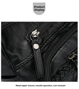 Detail of woven leather shoulder bag showing smooth metal multi-layer zipper system