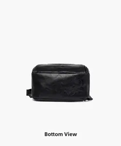 Detailed bottom view of black leather backpack showing durable texture and stitching