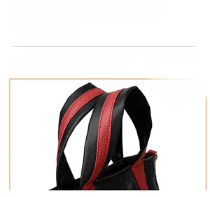 Close-up of dual-tone leather handle with litchi texture and red contrast stitching