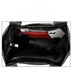 Spacious interior of black lychee leather tote bag with functional compartments
