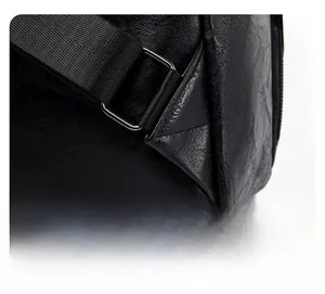 Detail of triangular reinforced stitching and black metal buckle on leather backpack