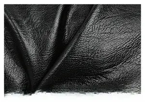 Close-up of high-quality black faux leather featuring a detailed lychee grain texture