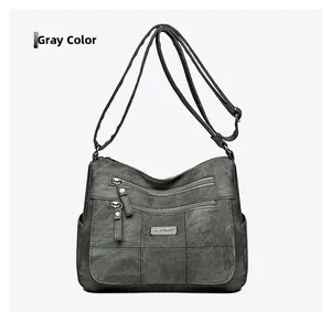 Detailed view of grey crossbody bag with matte texture and adjustable shoulder strap