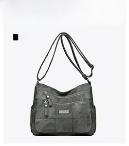 Front view of grey multi-pocket shoulder bag with matte texture and adjustable strap