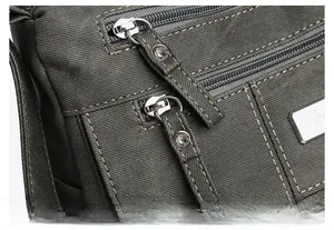 Detail of green canvas bag showing high-quality zipper and reinforced stitching