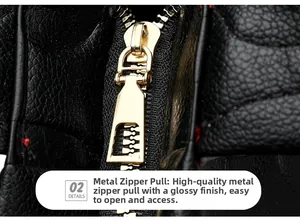 Detail view of premium golden zipper on textured black lychee grain leather tote bag
