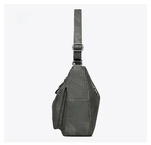 Side view of dark gray crossbody bag showing large capacity, pocket, and zipper detail